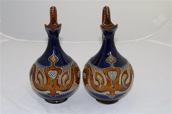 A pair of Doulton Lambeth Art Nouveau stoneware ewers, by Frank A Butler, c.1900, height 24cm (9.5in.)